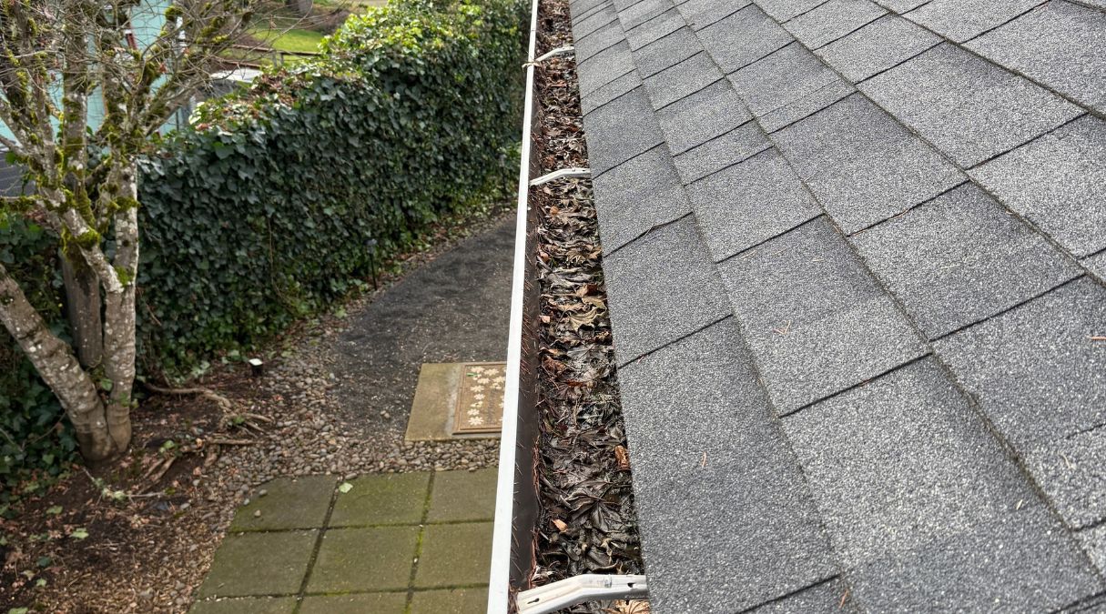 Gutter channel before cleaning with accumulated debris